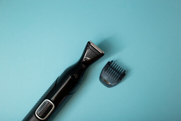 Electric shaver with attachments on a blue background