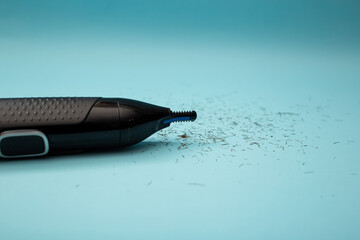 Electric shaver with attachments on a blue background