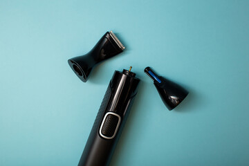 Electric shaver with attachments on a blue background