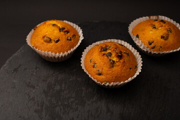 Juicy cupcakes on a black background, confectionery, bakery