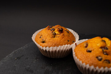 Juicy cupcakes on a black background, confectionery, bakery