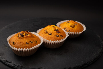 Juicy cupcakes on a black background, confectionery, bakery