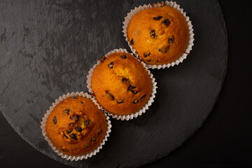Juicy cupcakes on a black background, confectionery, bakery