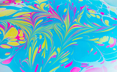 Traditional art of Ebru marbling. Abstract marbling floral pattern in blue, yellow and blue colors. Colorful texture of marble stains on the water, drawing pictures on the water by hand. Close up.