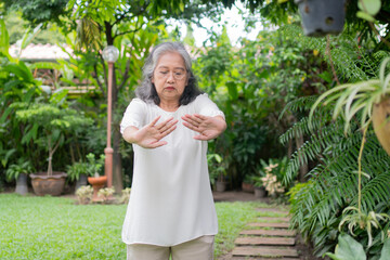 Portrait of a Asian Senior woman doing yoga and stretching exercise in the garden for a workout. Concept of lifestyle fitness and healthy. Asian women are practicing yoga in park. Healthy lifestyle