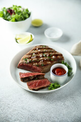 Grilled beef steak with tomato sauce