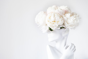 Fresh bunch of white peonies in vase in shape of womens face on light background. Trendy Ceramic Vase of human head, Handmade Modern Statue Art Flower Vase. Card Concept, copy space for text