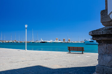 Obraz premium Rhodes Windmills in the Mandraki harbor and marina. Sightseeing in the old town. Rhodes, Greece