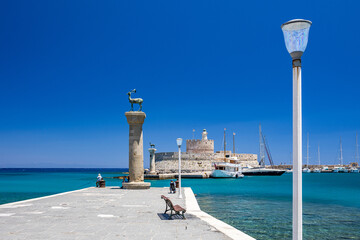 Entrance to Mandraki harbor and marina. Hirsch and Hirschkuh, Elafos and Elafina, bronze statues of...