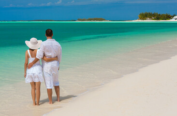 Loving Caucasian couple carefree on beach holiday Caribbean