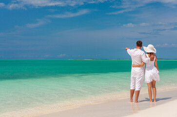 Loving Caucasian couple on beach by the sea