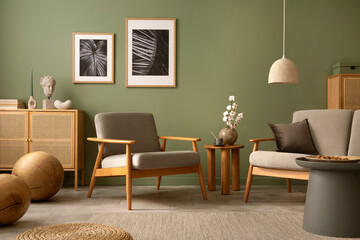 Stylish living room interior design with scandi armchair, elegant commodes, mocj up poster frames and accessories. Green wall. Template. Copy space.