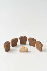 Pieces of bread with one in center on white