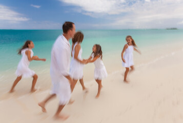 Fototapeta na wymiar Happy Caucasian family white clothes running along beach