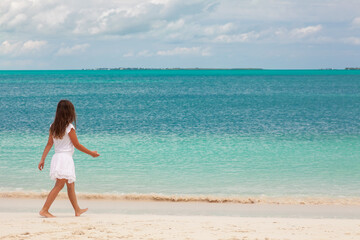 Fototapeta na wymiar Happy young Caucasian child walking in tropical Caribbean