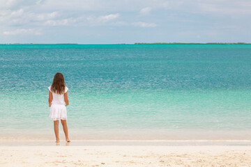 Fototapeta na wymiar Healthy young Caucasian child walking along Caribbean beach