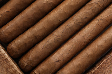 Closeup of many cigars as background, top view