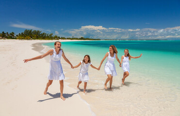 Young Caucasian parents and children beach fun together