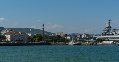 Fototapeta na wymiar View of Novorossiysk Embankment of Admiral Serebryakov from side of Western mole. Novorossiysk, Russia - September 15, 2021