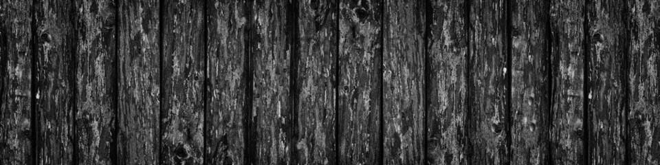 Black rough wooden board wide banner texture. Old knotty wood plank large widescreen background. Dark gloomy grunge backdrop