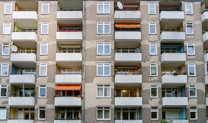 Facade of a block of flats with balconies that is being renovated