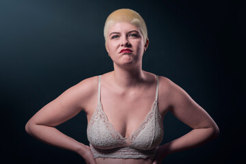 studio portrait of a young woman defiantly twisting her mouth