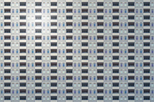 architectural pattern, high-rise building with a dreary gray concrete facade and balconies