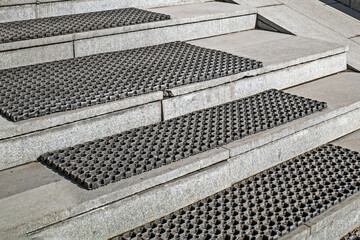 Porch steps with rubber anti-slip mats on a sunny day