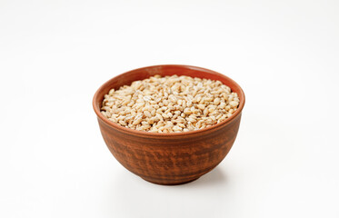 Barley groats in bowls and bags isolated on a white background. High quality photo