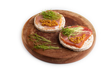 Puffed rice cake sandwiches with jerky salted meat, carrot microgreen isolated on white, side view,...