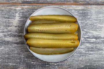 marinated cucumber on a gray wooden background. Top view, close up.