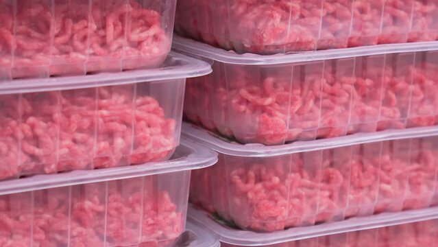 Minced meat in plastic packages on supermarket shelves. Selective focus