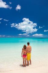 Male and female couple barefoot on beach Caribbean