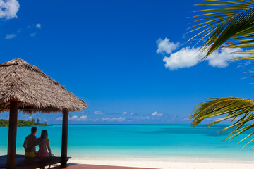 Fototapeta na wymiar View of beach tropical house with couple Caribbean