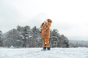 Little boy in a winter park or forest