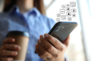 Different virtual icons and young woman using smartphone indoors, closeup. SMM (Social media marketing) concept