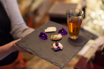 Tea served with cheese crackers and flowers 