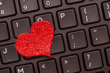 A red heart on a laptop keyboard