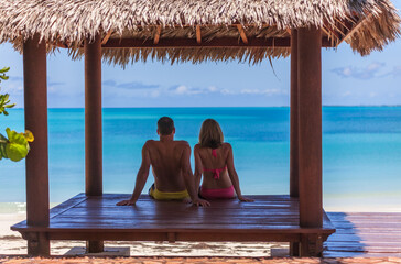 Loving Caucasian couple in tropical house on beach