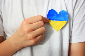 A child holds a Ukrainian heart in his hands