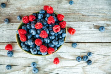 Top view fresh ripe blueberry and raspberry in a bowl