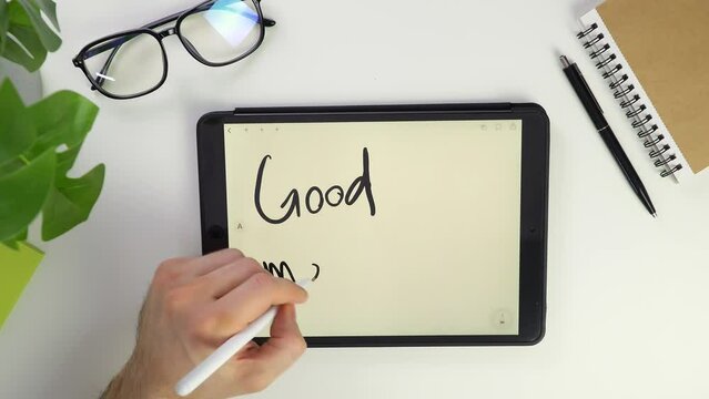 good morning online text Write note on tablet screen. Electronic pencil for widget notes. Modern reminder on the screen. Top view of a white desktop in office. Screen glasses. Pocket laptop 