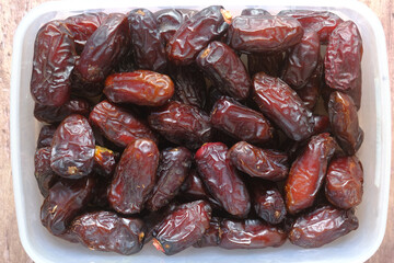 close up of fresh date fruit in a bowl on table 