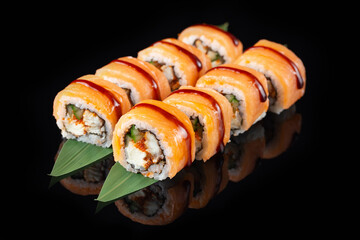 Traditional delicious fresh sushi roll set on a black background with reflection. Sushi roll with rice, nori, cream cheese, tobiko caviar, avocado. Sushi menu. Japanese kitchen. Asian food