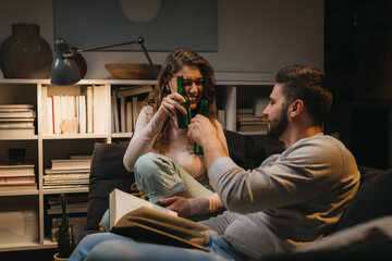 couple drinking beer at home. evening night scene