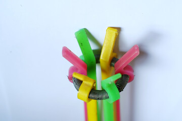 Close up of colorful lamp changer clamps on white background