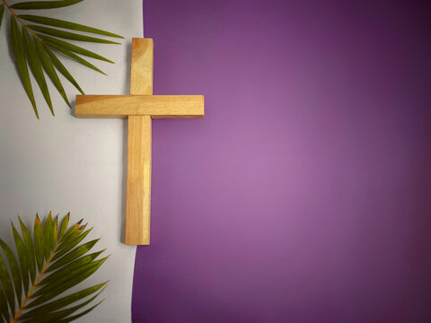Lent Season,Holy Week and Good Friday concepts - image of wooden cross in purple and white vintage background. Stock photo.
