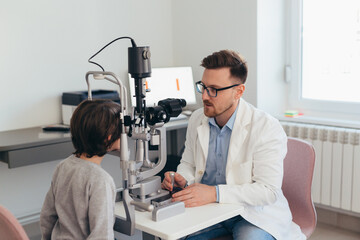 doctor checking eye sight of boy