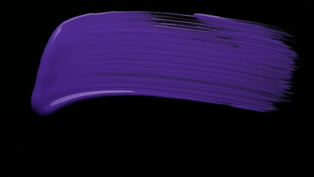 Brush painting purple on black background. High quality 4k footage