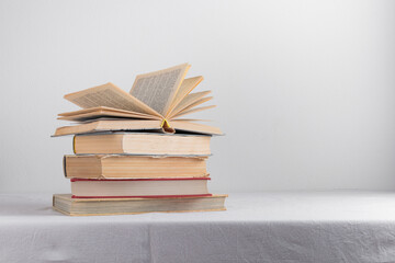 Stack of old rustic vintage books on white table 